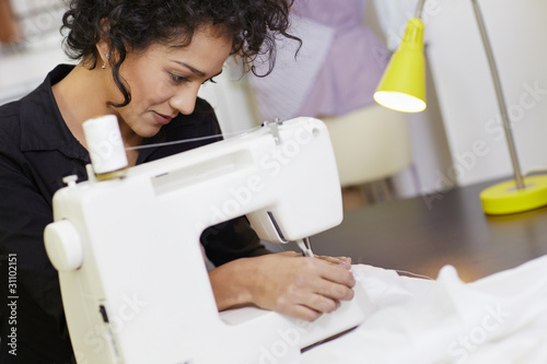 Photo: Fashion designer with sewing machine Fashion designer with sewing machine