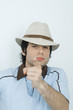 Young man wearing hat, pointing at camera