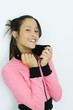 Teen girl wearing sweatshirt, holding up collar, portrait