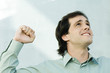Man clenching fist, looking up, portrait