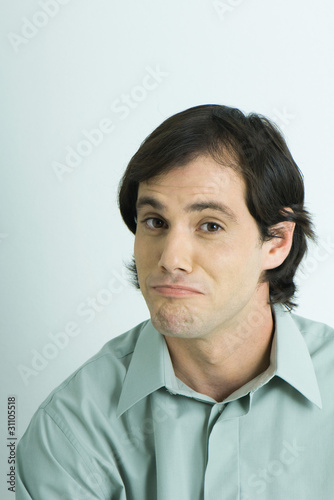 Photo: Man raising eyebrows, wrinkling chin, portrait Man raising eyebrows, wrinkling chin, portrait