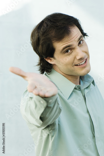 Photo: Man holding out hand to camera, portrait Man holding out hand to camera, portrait