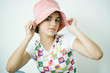 Teen girl putting on hat, portrait