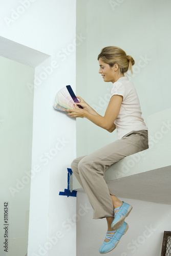 Photo: Woman looking at color swatches Woman looking at color swatches