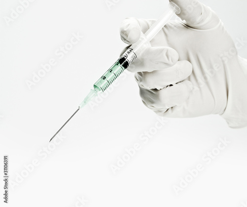 Photo: Syringe in doctors hand Syringe in doctors hand