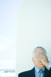 Mature businessman, hand covering eyes, head and shoulders