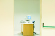 Office with desktop computer, view through doorway