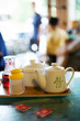 Tray with tea service and table markers on table in restaurant