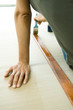 Woman staining piece of wood, cropped view