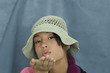 Teenage girl looking at camera, blowing a kiss, portrait