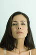 Woman looking down nose at camera, portrait