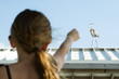 Little girl pointing at heron, rear view