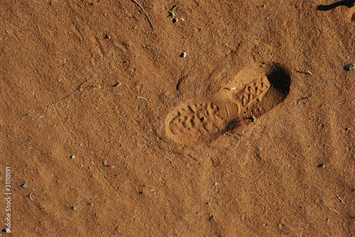 Photo: Shoeprint in sand, high angle view, close-up Shoeprint in sand, high angle view, close-up
