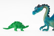 Toy dinosaur facing toy dragon