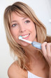 Portrait of beautiful woman brushing her teeth