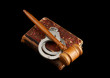 Photo: Judge's gavel and handcuffs on old legal book isolated Judge's gavel and handcuffs on old legal book isolated