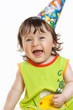 Funny girl in birthday cap isolated on white