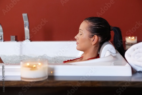 Photo: Young woman enjoying bubble bath Young woman enjoying bubble bath