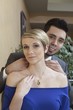 Photo: A couple in a luxurious jewellery shop, where the man is holding an exclusive necklace around the females neck A couple in a luxurious jewellery shop, where the man is holding an exclusive necklace around the females neck