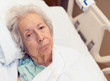Elderly 80 year old woman with Alzheimer in a hospital bed