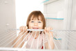 Girl looking in empty fridge