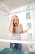 Teenager and empty fridge Teenager and empty fridge