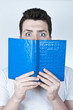 Afraid man reading a book
