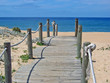 Wooden boardwalk ending at beach. Wooden boardwalk ending at beach.