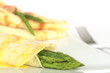 Green asparagus wrapped in crepes with sauce Green asparagus wrapped in crepes with sauce