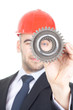 Young handsome engineer examine a gear Young handsome engineer examine a gear
