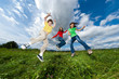 Active family - mother and kids jumping outdoor
