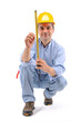 Construction worker measuring the wall over white background. Construction worker measuring the wall over white background.