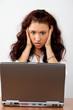 Business woman looking surprised to the laptop screen