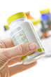 A fényképek részletei Hand holding medicine bottle