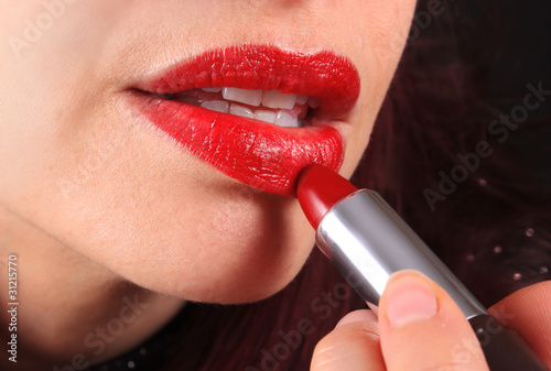 Photo: Applying lipstick to luscious lips Applying lipstick to luscious lips