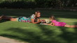 Girl draws on the lawn with his mother