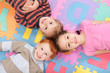 Children having fun on kids alphabet mat