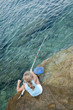 Little girl fishing  at the beach