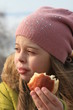 Girl holding bite off doughnut