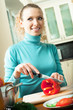 Happy smiling woman cooking with vegetables, at home Happy smiling woman cooking with vegetables, at home