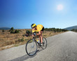 Cyclist riding a bike on an open road in Macedonia