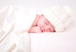 Little Newborn Baby Sleeping on White with Blanket
