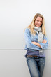 Blond woman standing on grey background