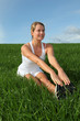 Beautiful woman doing fitness exercises in nature