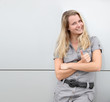 Smiling blond woman on grey background