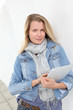 Portrait of beautiful blond woman using electronic tablet
