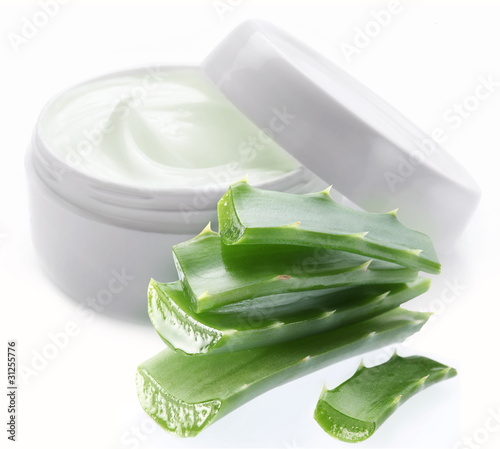 Photo: Opened plastic container with cream and aloe. Opened plastic container with cream and aloe.