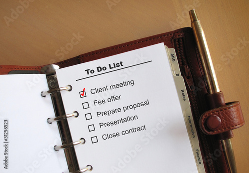 Photo: Business concepts to do list in a personal organizer Business concepts to do list in a personal organizer