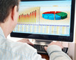 Analyzing financial data and charts on computer screen. Analyzing financial data and charts on computer screen.