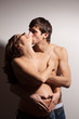 Handsome man kissing pregnant woman